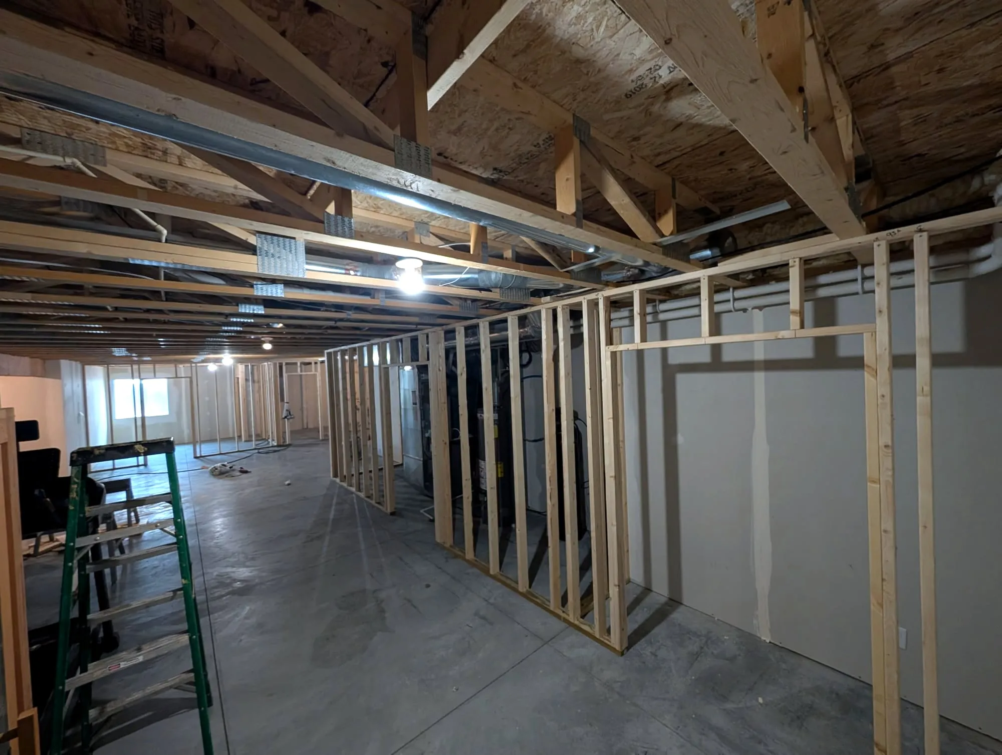 New wall framing under exposed floor trusses
