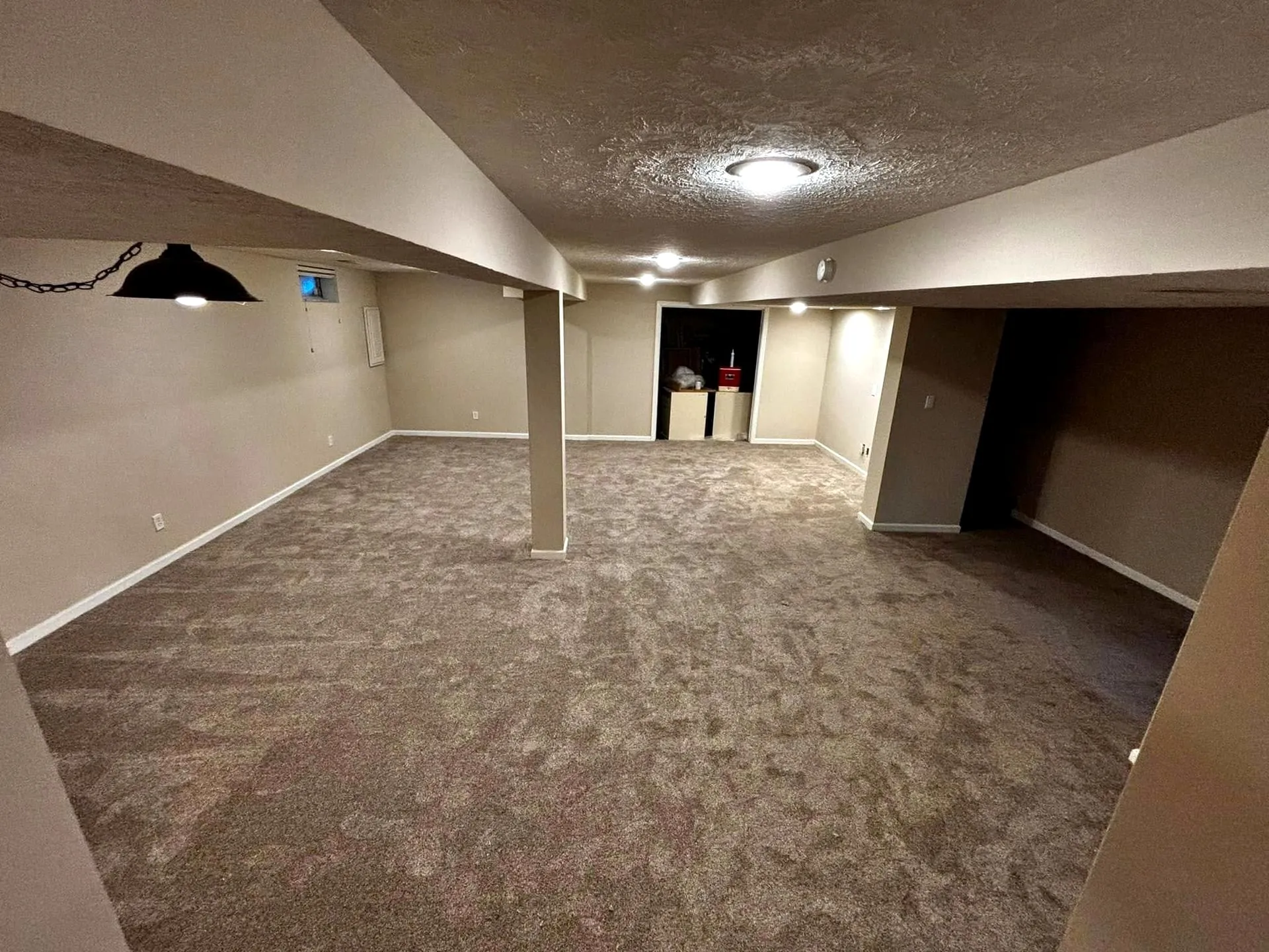Finished basement with new carpet and fresh paint