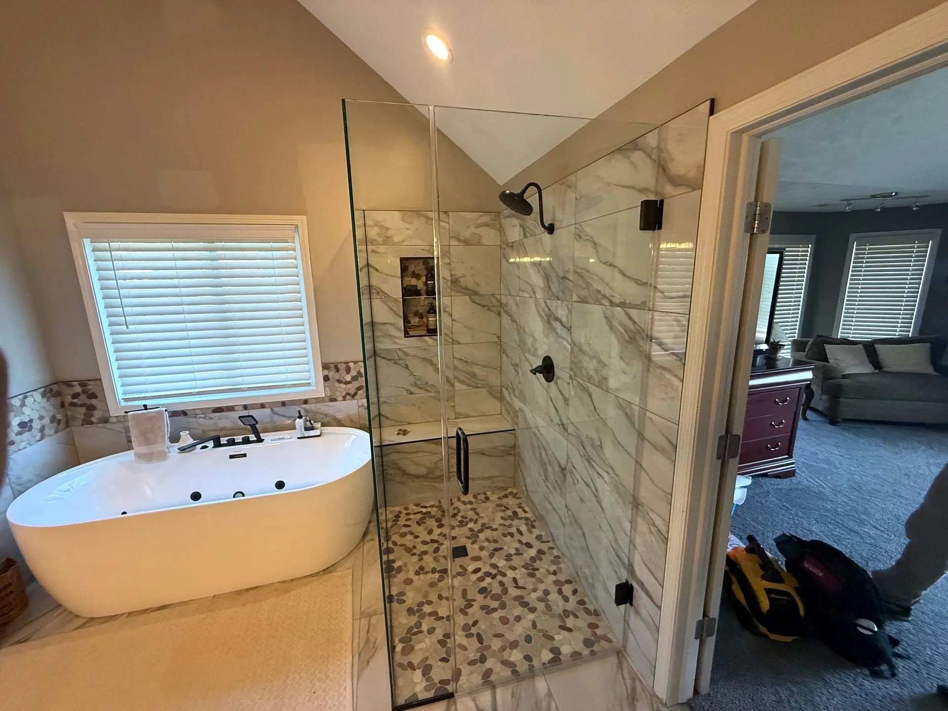 Bathroom with a tiled walk-in shower and freestanding tub