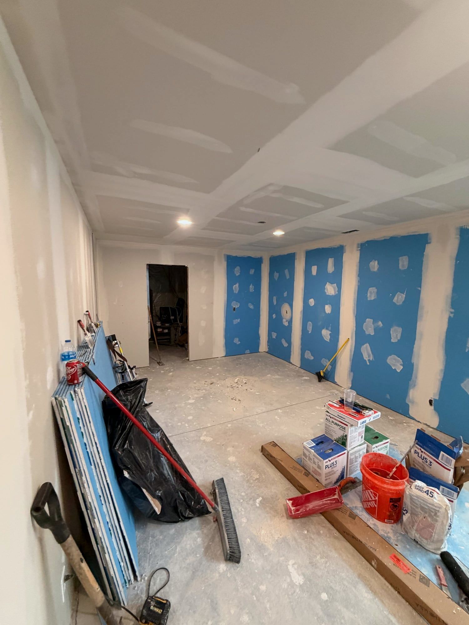 Basement with new drywall hung, taped and mudded