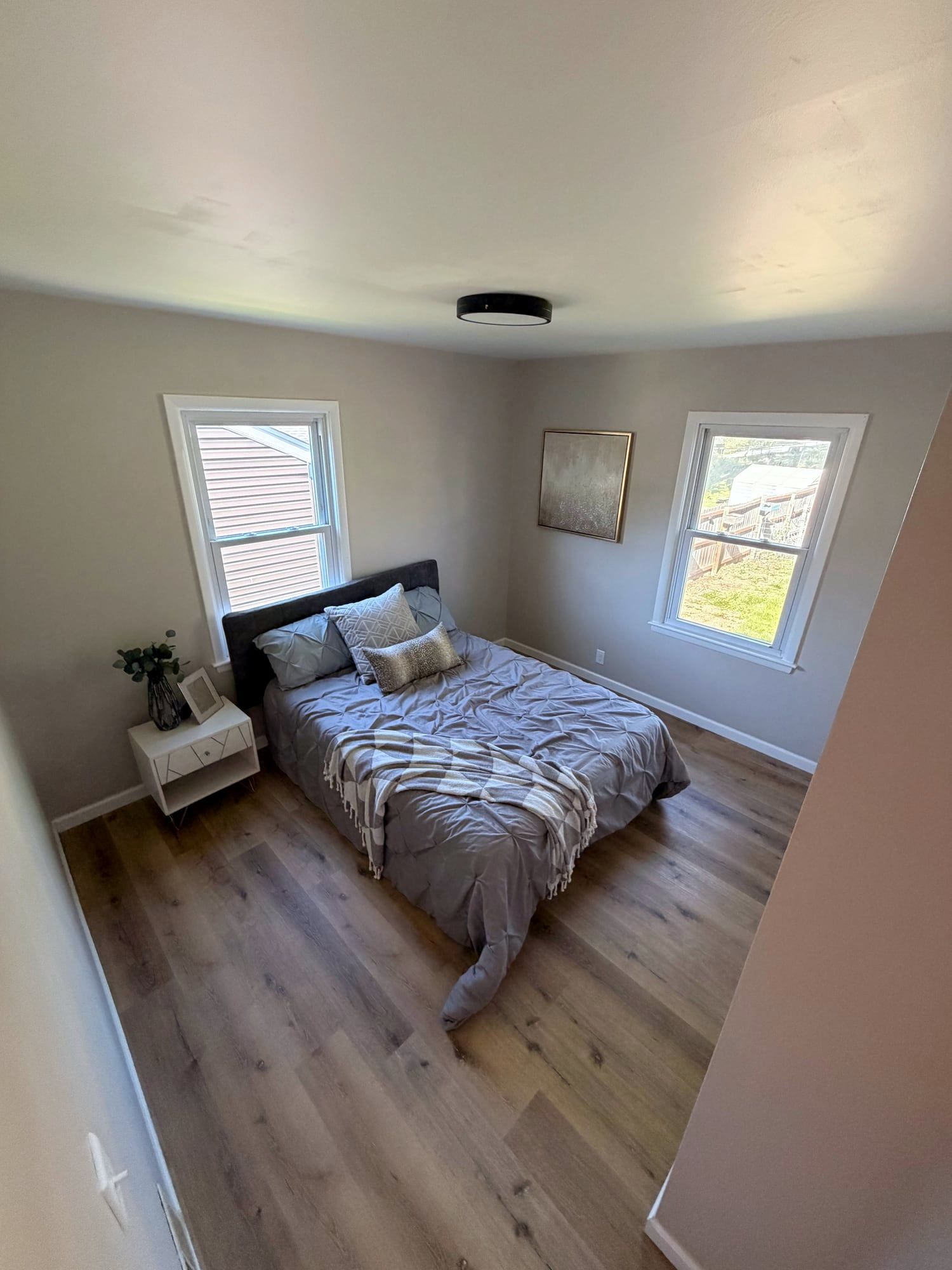 Bedroom with new wood-look vinyl plank flooring and fresh paint