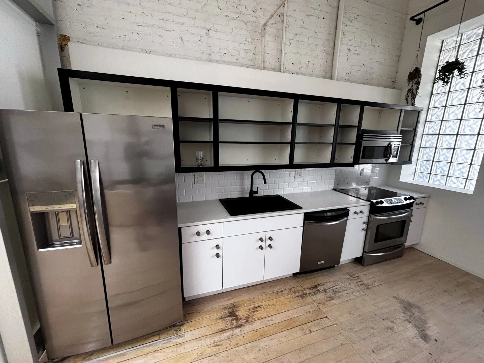 Kitchen with white cabinets and open shelving