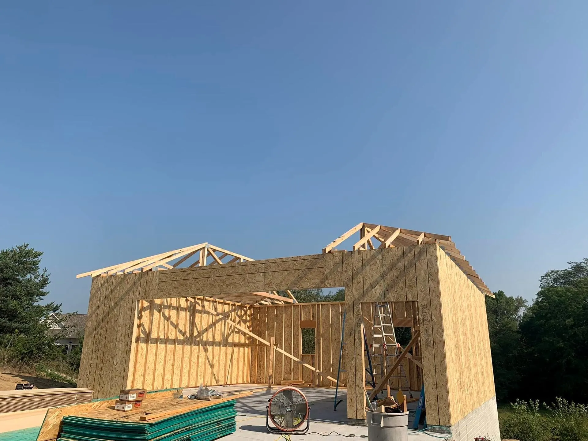 Garage addition framed with roof trusses going up