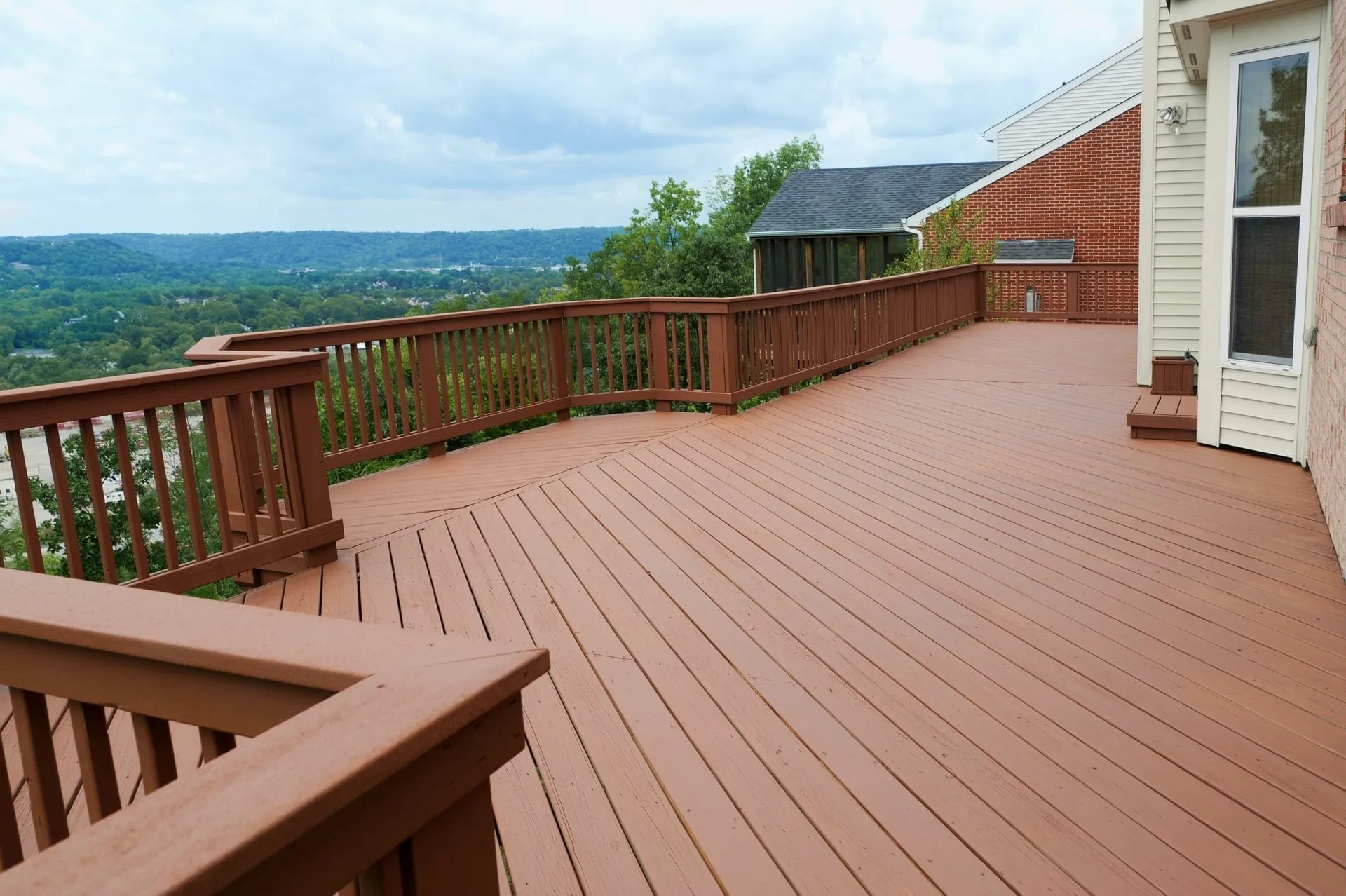 Large stained deck with a new railing
