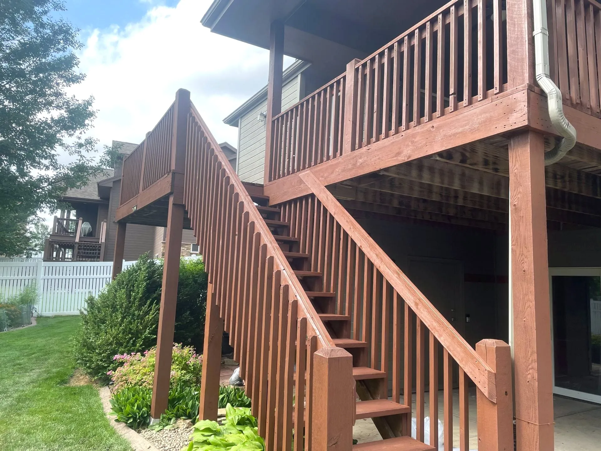 Stained deck staircase to an upper deck
