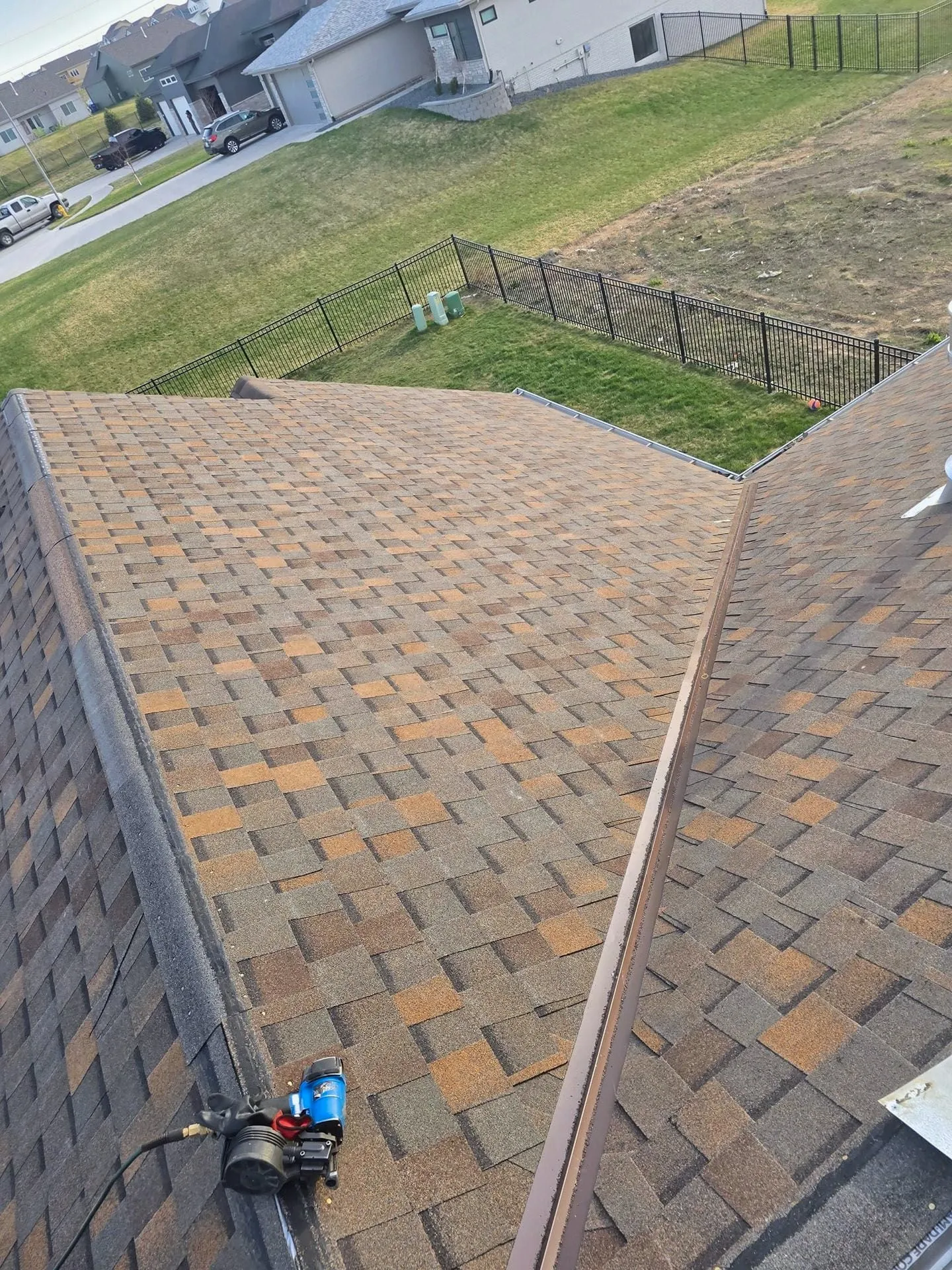 New brown shingle roof with a valley